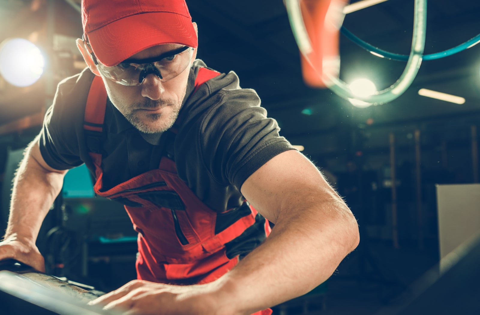 A male metalworker wearing prescription safety glasses while he works