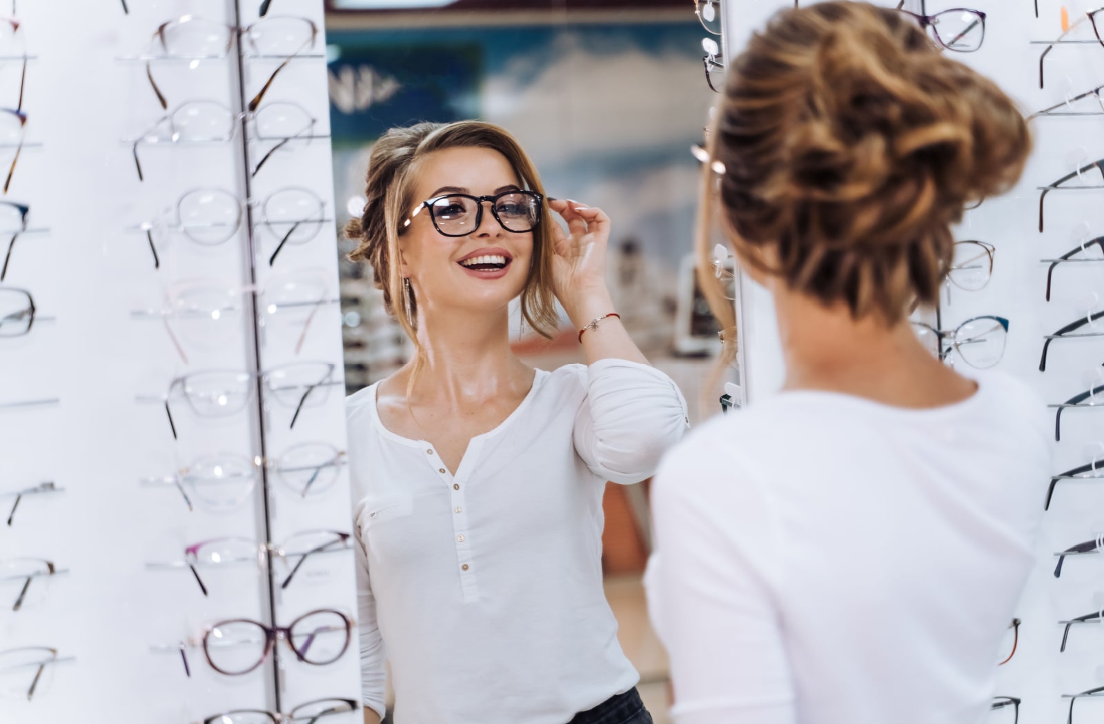 A woman trying on a pair of glasses at the optometrist's office