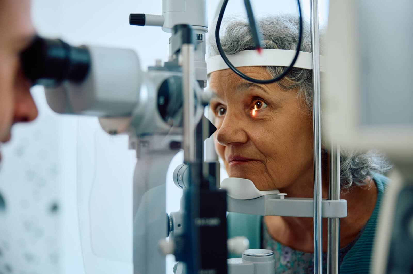 Senior having their eyesight checked at ophthalmology clinic.