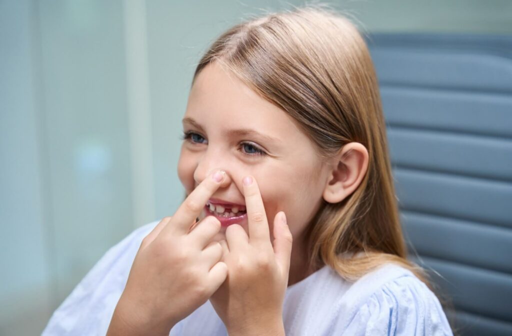 Smiling girl putting on contact lenses.