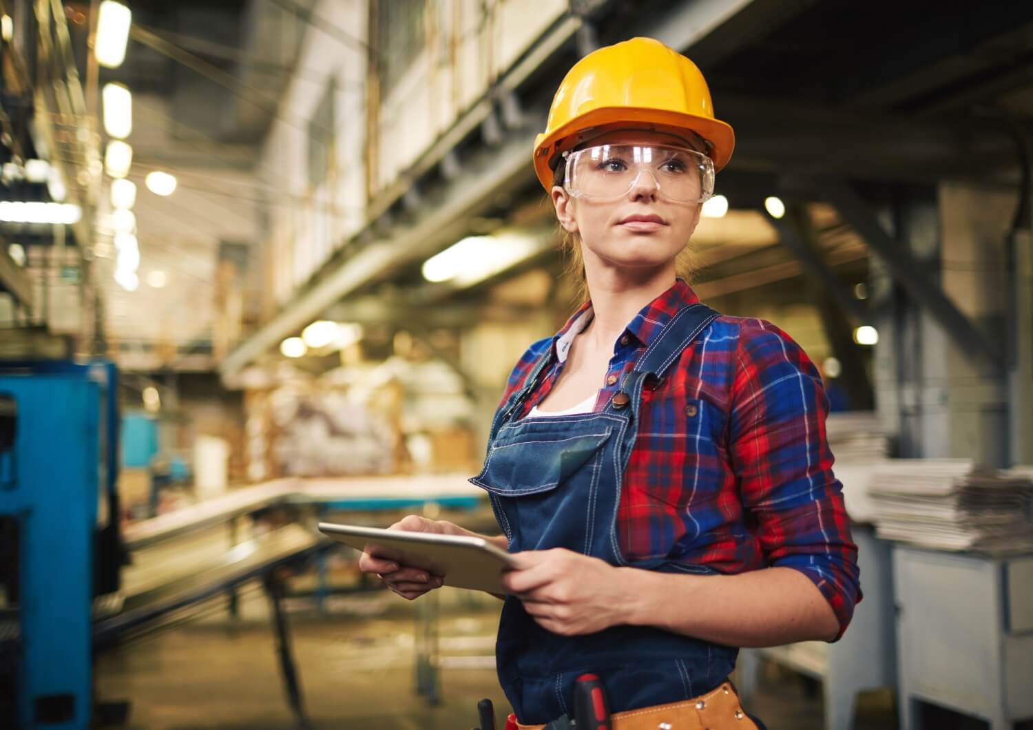 Factory working wearing safety glasses.